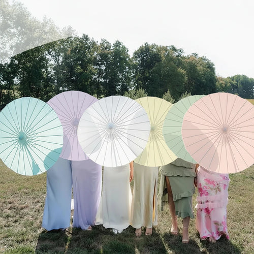 People holding pastel-colored umbrellas in a field with text 'Wedding Gift For Guest'.