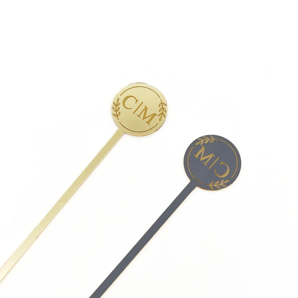 Two gold and one gray stirrer with 'CIM' logo on a white background